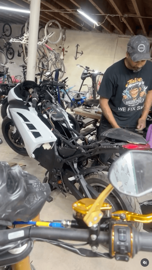 Technician servicing an electric motorcycle at Juice Junkiez in Baltimore, Maryland